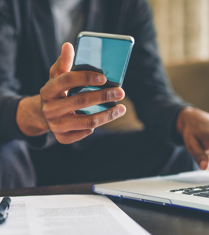 man's hand holding phone