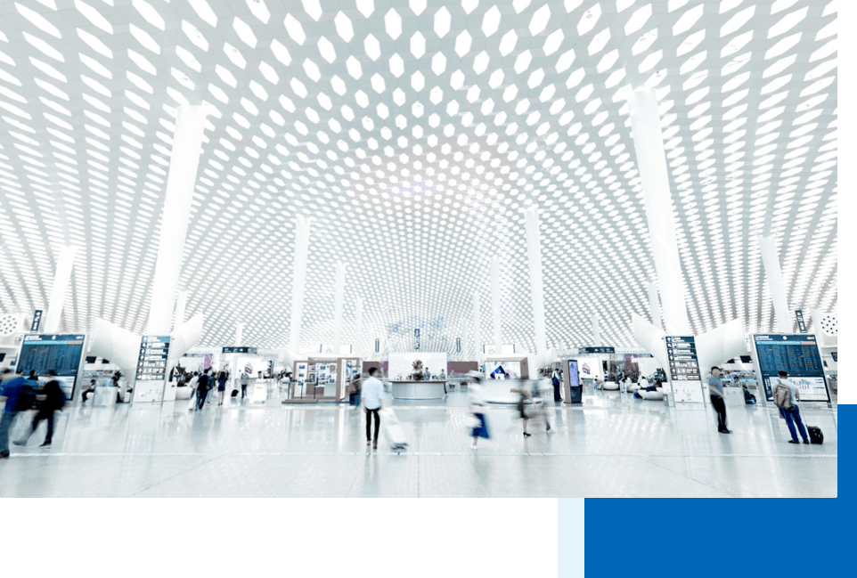 Bright white airport terminal in Shenzhen Bao'an International Airport with fast moving passengers