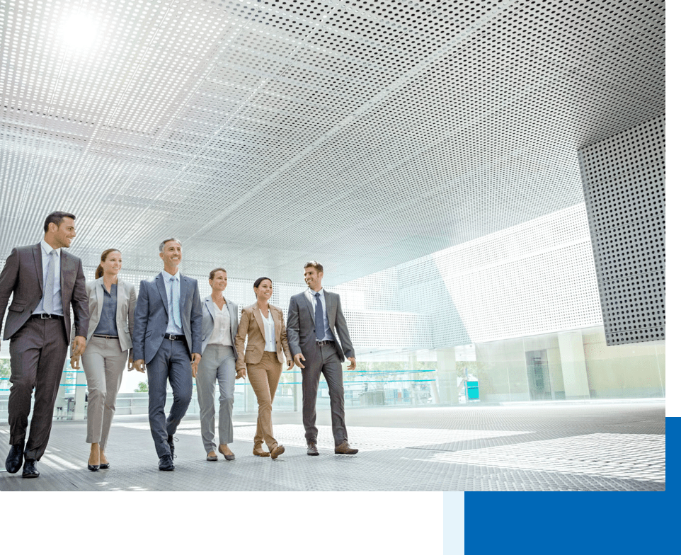 Row of men and women in business attire walking through a modern office