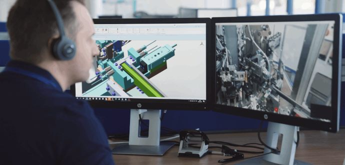 Automotive technician sitting at computer screens