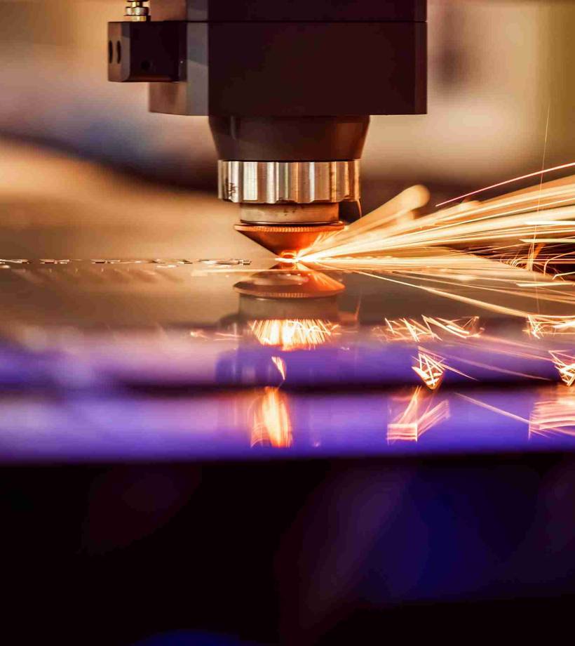 Laser machine grinding sparks and purple light