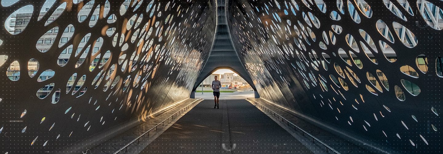 Man jogging through an ornate tunnel
