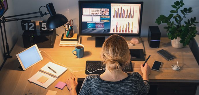 Woman sitting at her desk in front of a computer