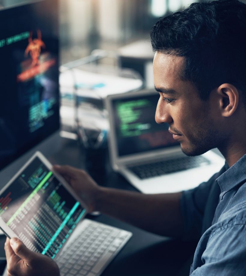 A man looking at a tablet screen with data