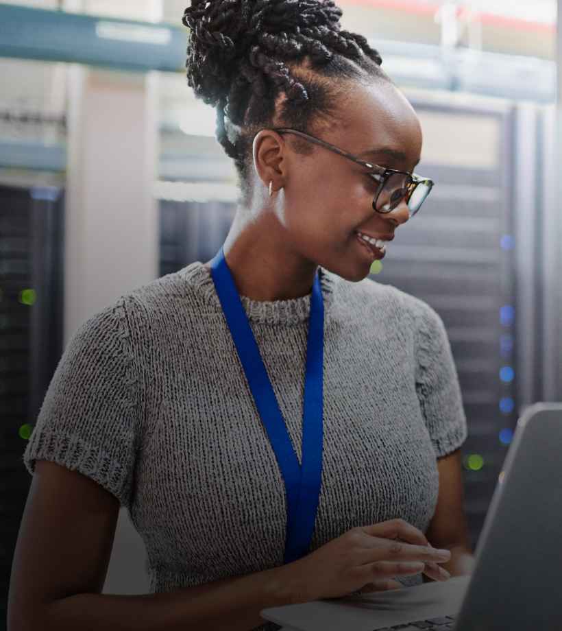 An employee at the data center looking at the laptop screen