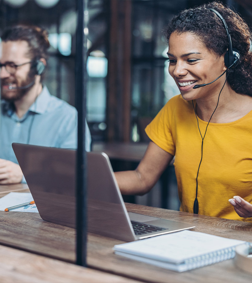 A woman smiling sitting next to a man