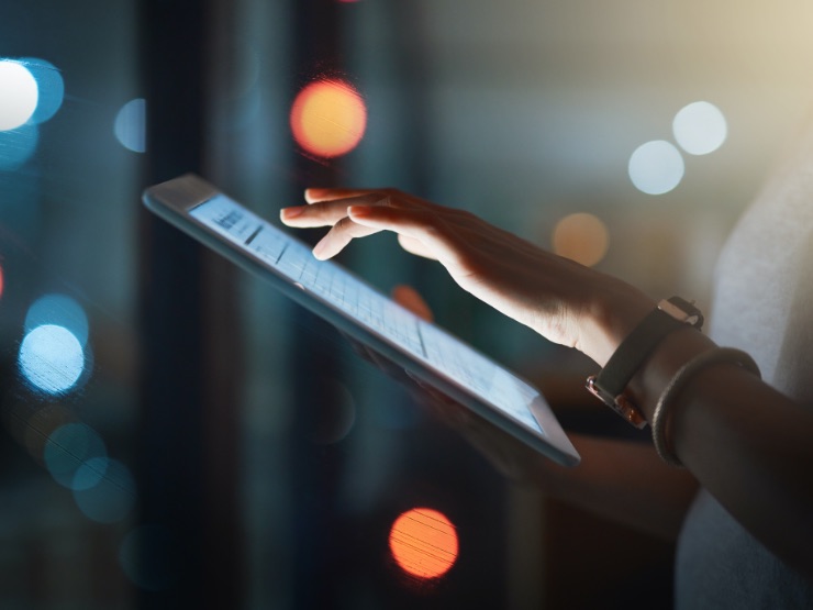 Woman typing on a tablet